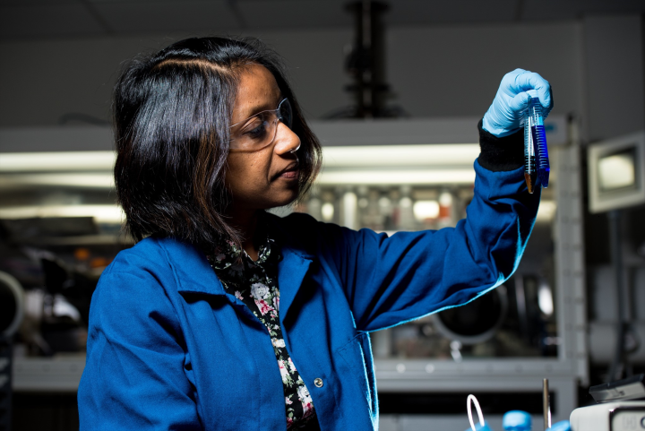 PSDP researcher examining a sample in the laboratory